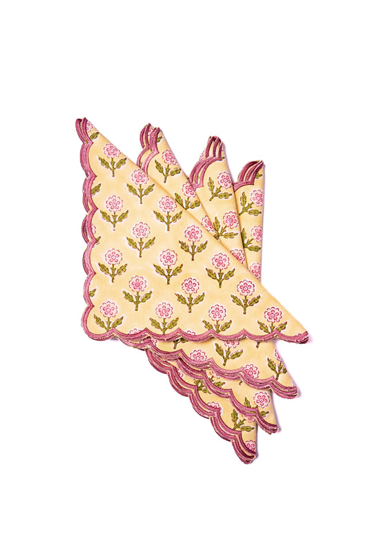 Butter yellow scalloped napkin with pink floral blockprint and embroidered edge