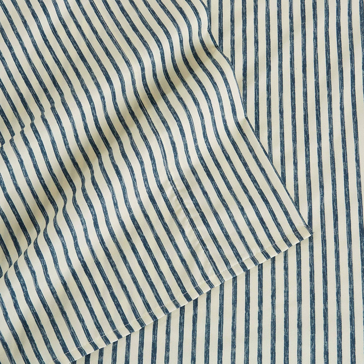 Close-up of blue striped microfiber fabric with narrow vertical lines