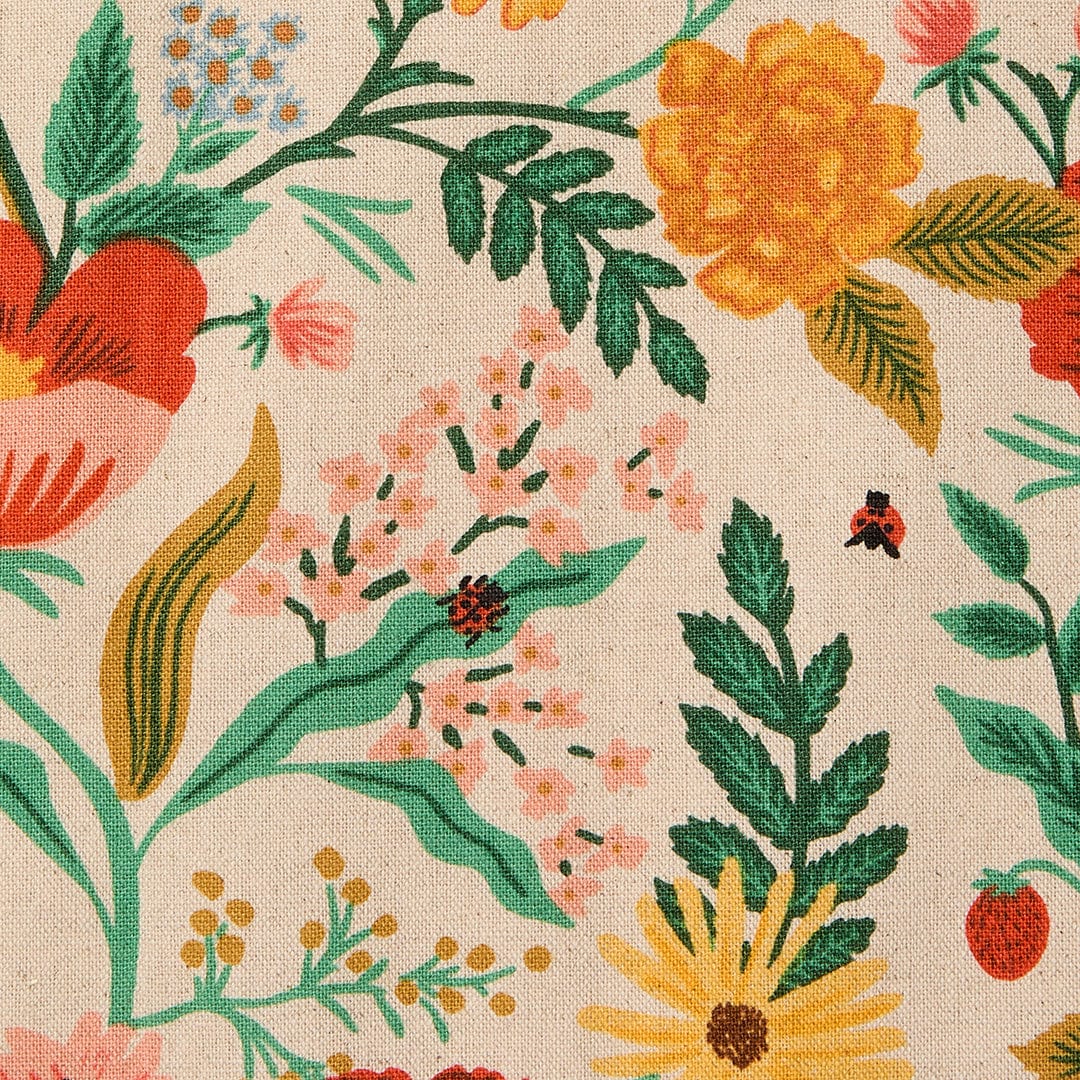 Close-up of cream floral pattern with leaves, flowers, and small insects