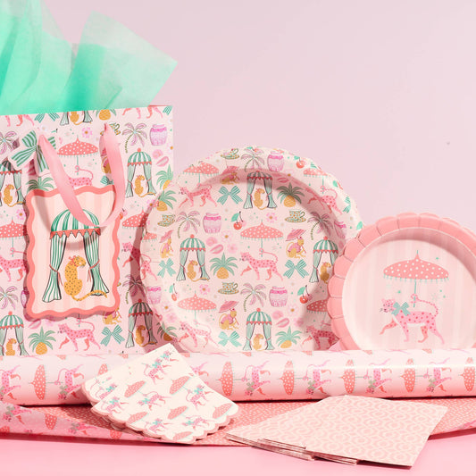 Pink patterned dessert plates set with matching napkins and folded tissue paper