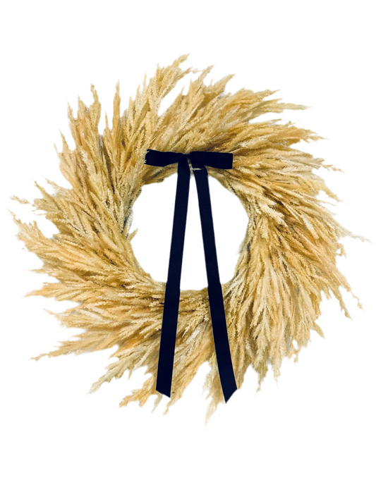 Fall pampas wreath with navy bow ribbon on golden feathery fronds