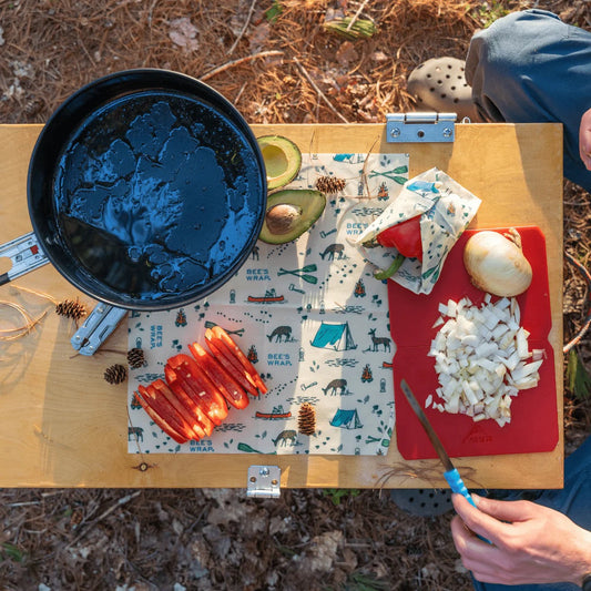 Reusable food wraps with navy animal pattern laid on a tray outdoors