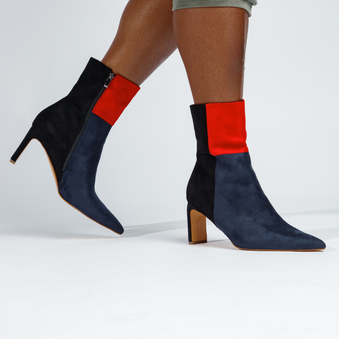 Color-block ankle booties with red-and-black top band, navy suede, slim heel