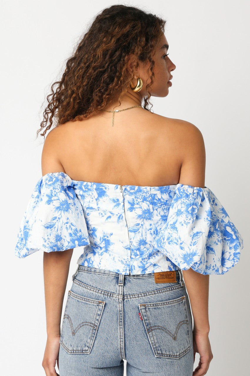 Blue floral off-shoulder puff sleeve crop top with back cutout and ruffled hem