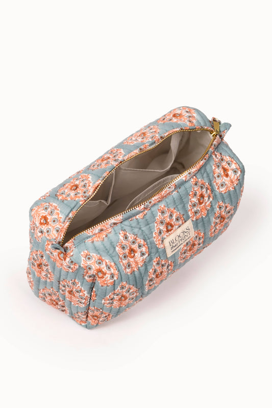 Quilted travel pouch with terracotta buta block print; open zip shows gray interior lining