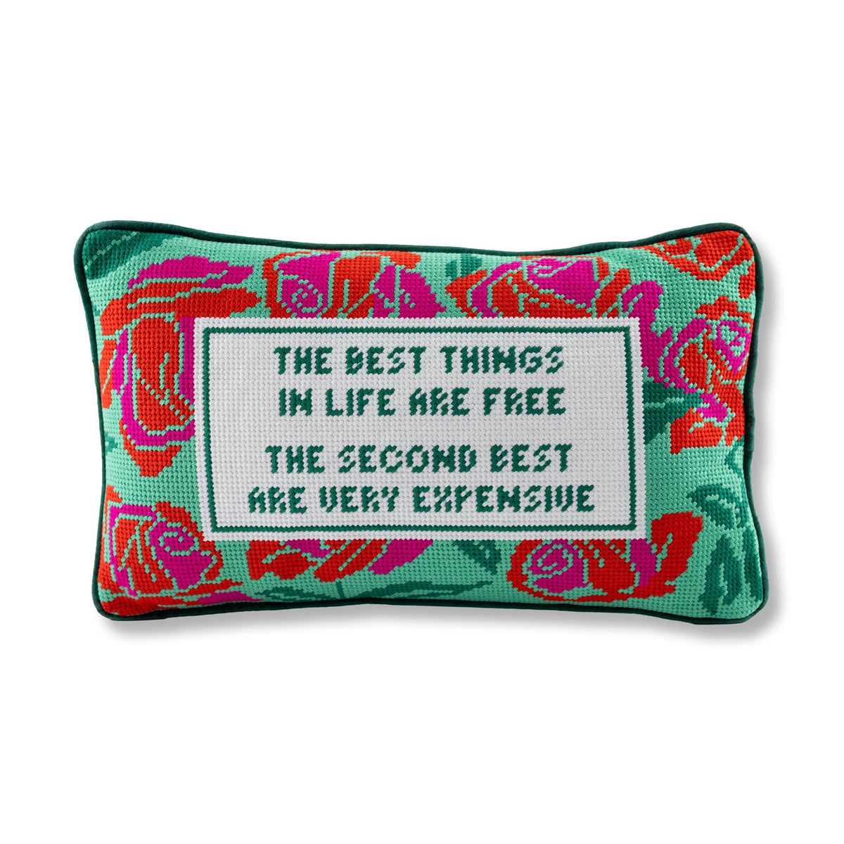 Embroidered needlepoint throw pillow with green edging, red floral motifs, and quote text