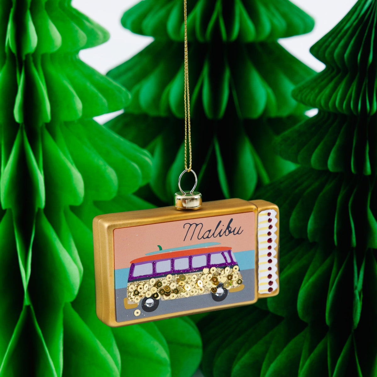 Matchbook ornament with Malibu logo and sequined car, hanging from gold string.