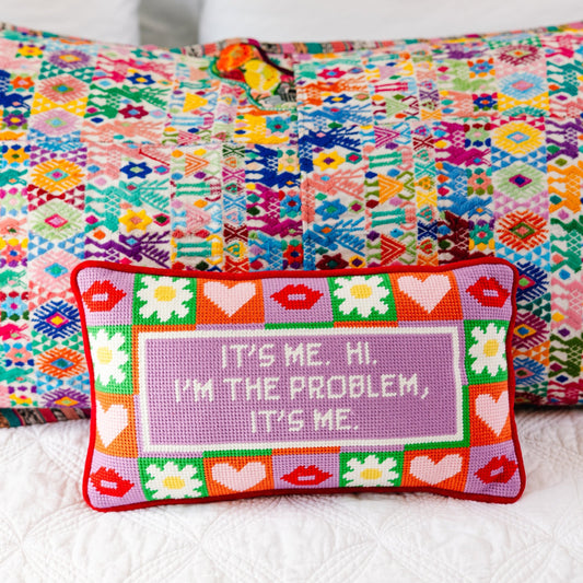 Needlepoint decorative pillow with red trim, heart pattern, and purple "It's me" quote panel