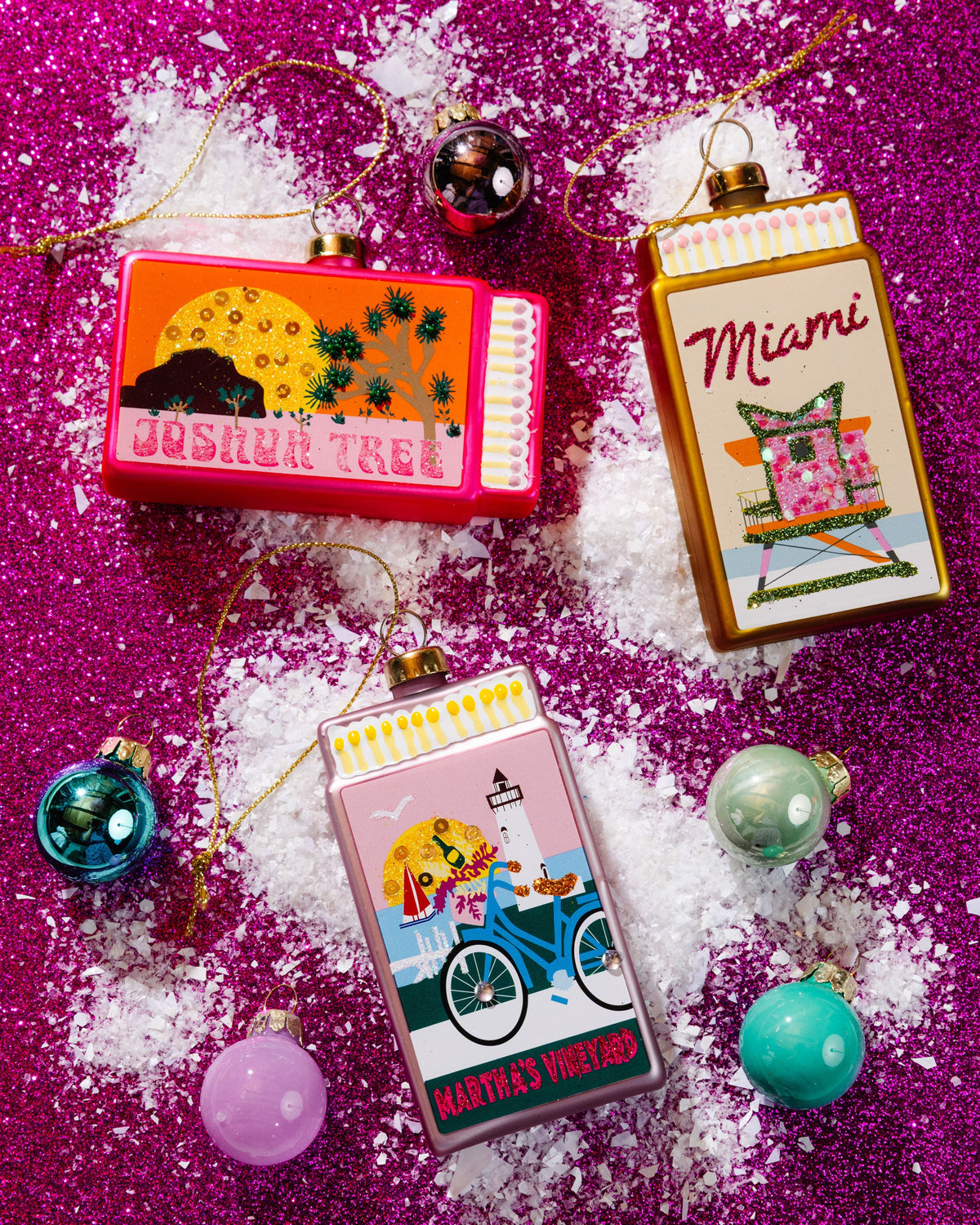 Miami matchbook ornament with gold top, shown with other matchbook ornaments on glitter