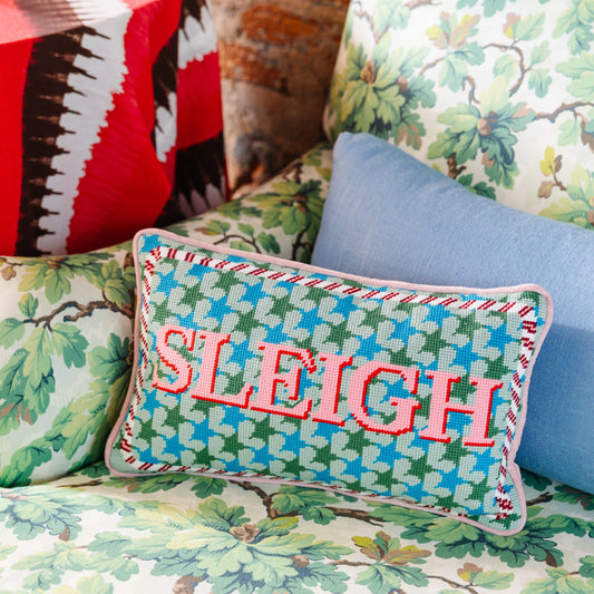 Needlepoint holiday throw pillow with 'SLEIGH' lettering on teal, green, blue houndstooth pattern