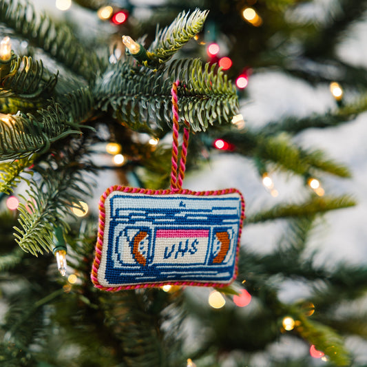 Needlepoint VHS tape ornament hanging from braided cord, blue stitched cassette design