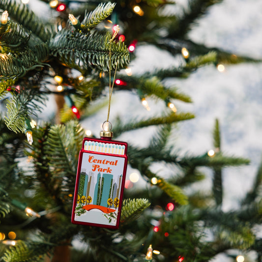 Hanging matchbook-style ornament with red border and Central Park graphic