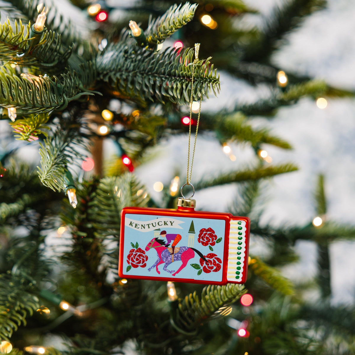 Kentucky matchbook ornament with gold hanging loop and red patterned front