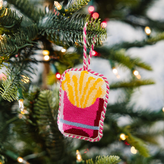 Needlepoint French fries ornament hanging from striped cord, pink and yellow stitched square