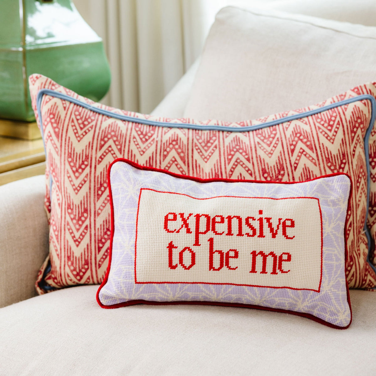 Red chevron needlepoint pillow with “expensive to be me” text panel