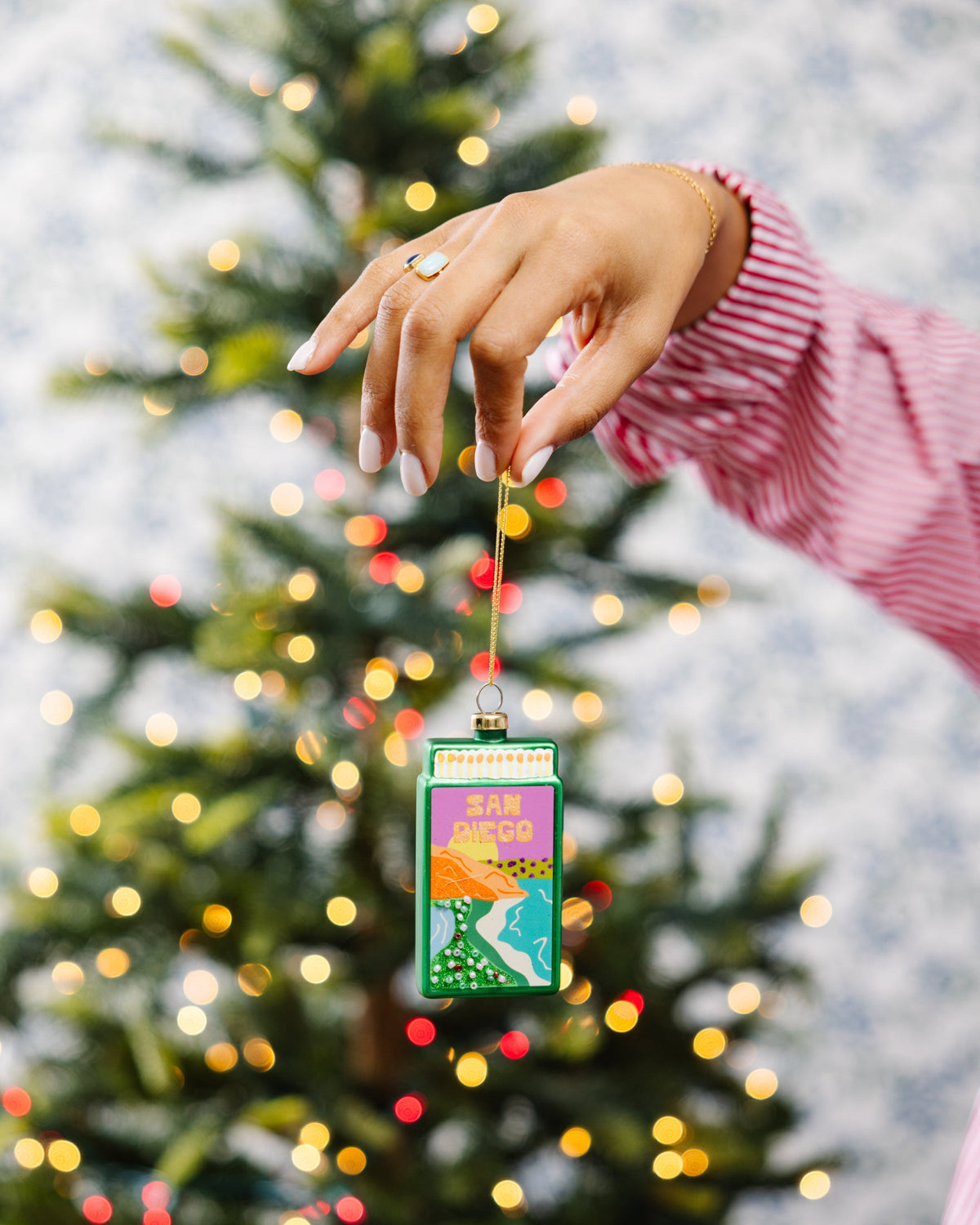 Matchbook ornament with 'SAN DIEGO' design hanging from a Christmas tree