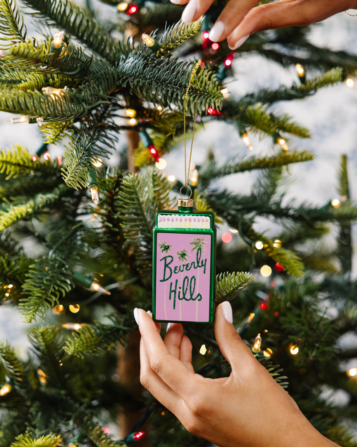 Matchbook ornament with 'Beverly Hills' text, green border, gold top cap and hanging loop