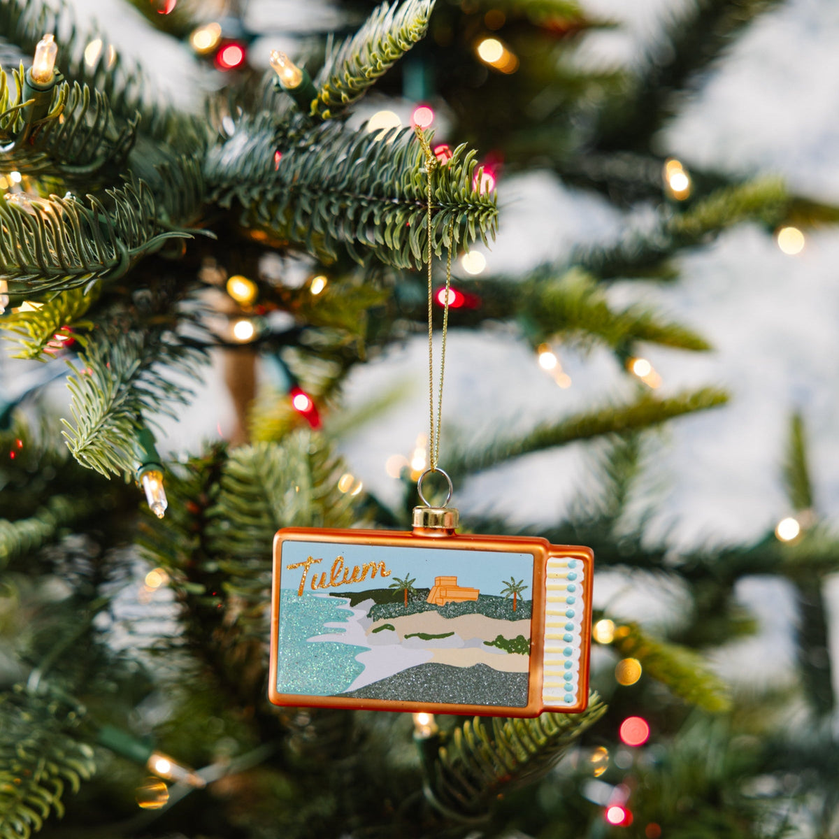 Hanging Tulum matchbook ornament with orange border and glitter beach illustration