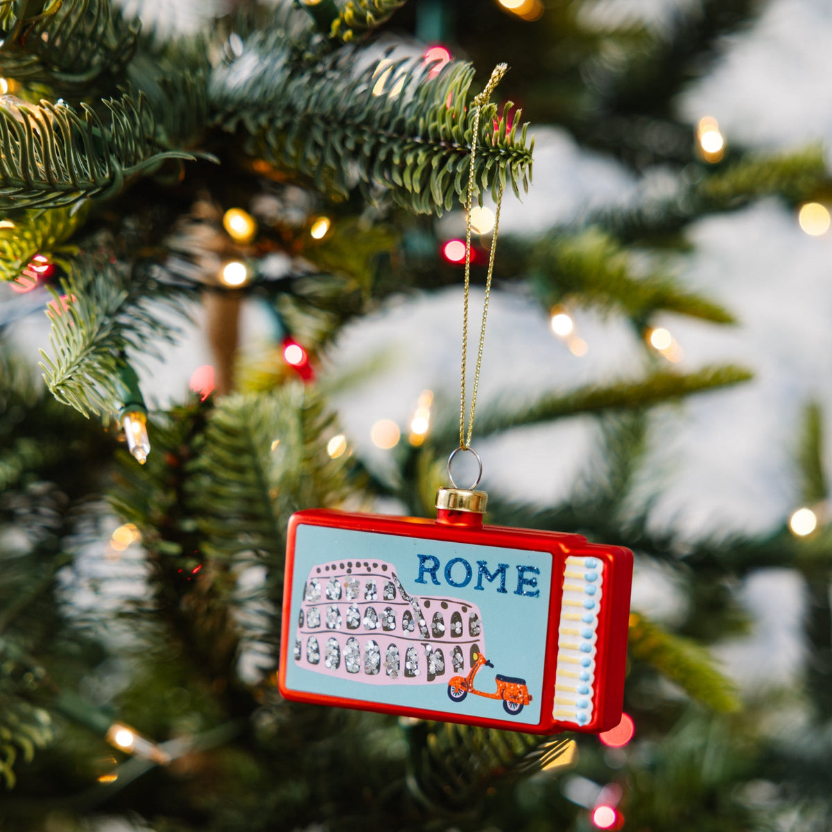 Rome matchbook ornament hanging from a gold cord
