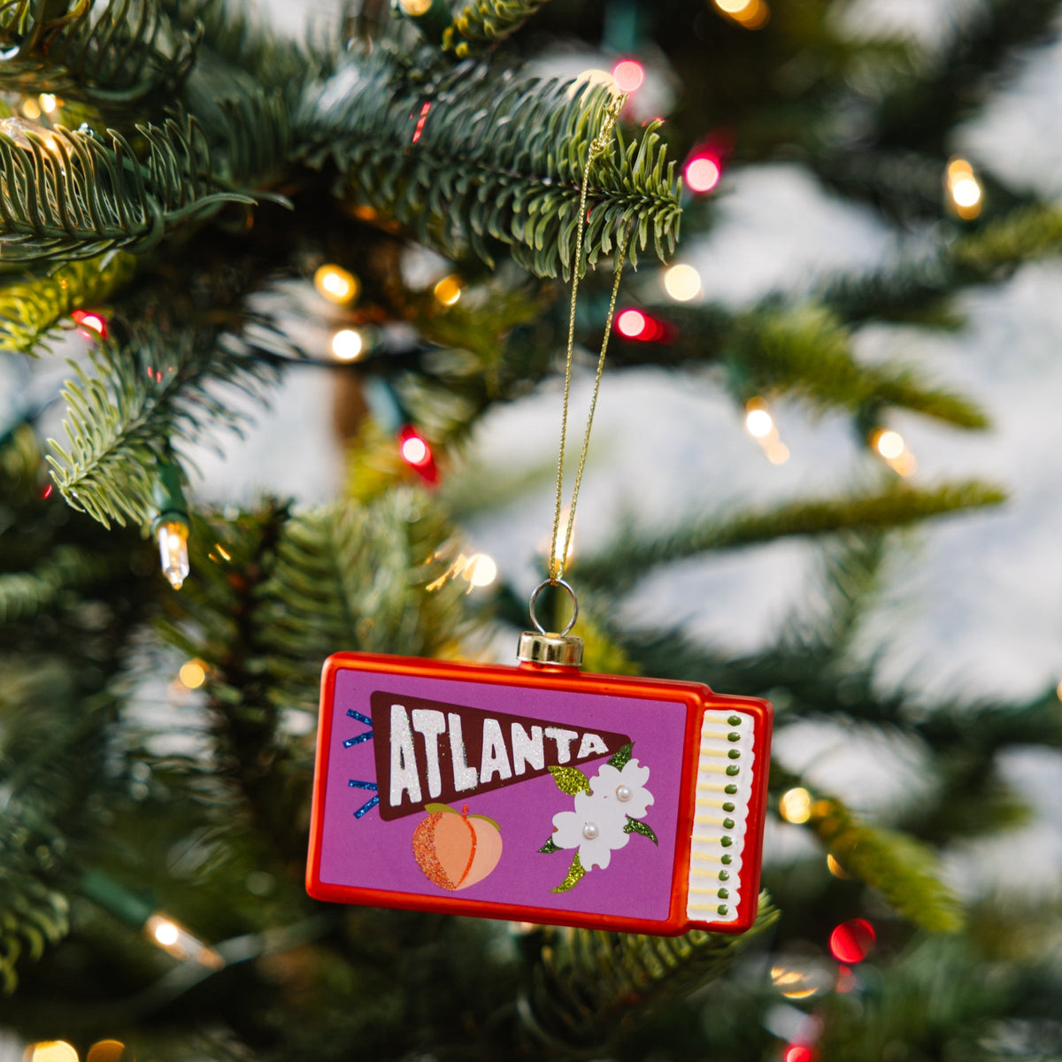 Atlanta matchbook ornament hanging on a gold string