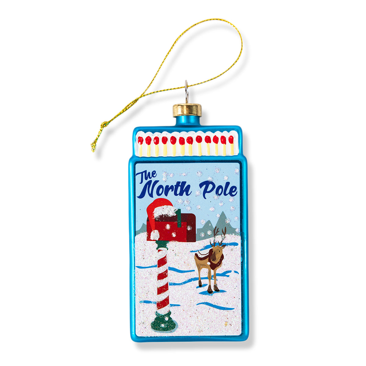 Blue matchbook-style ornament with “The North Pole” scene and hanging loop.