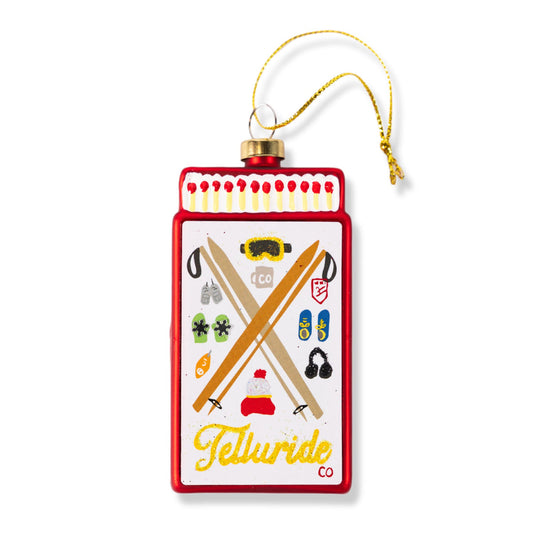 Red Telluride matchbook ornament with hanging gold cord and pictorial graphic