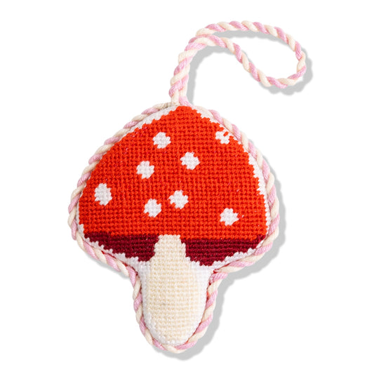 Needlepoint mushroom ornament with red cap, white spots, and off-white stem with loop