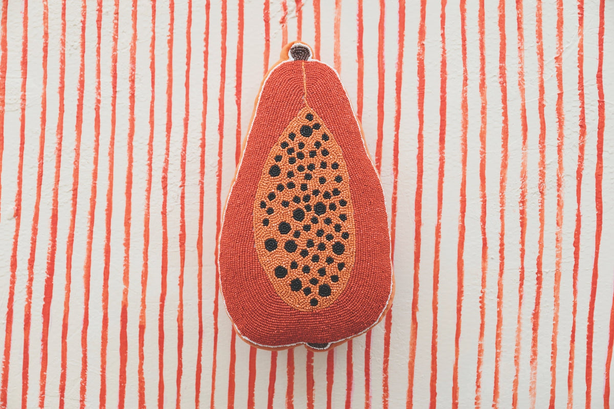 Papaya-shaped accent pillow front view with hanging loop at top