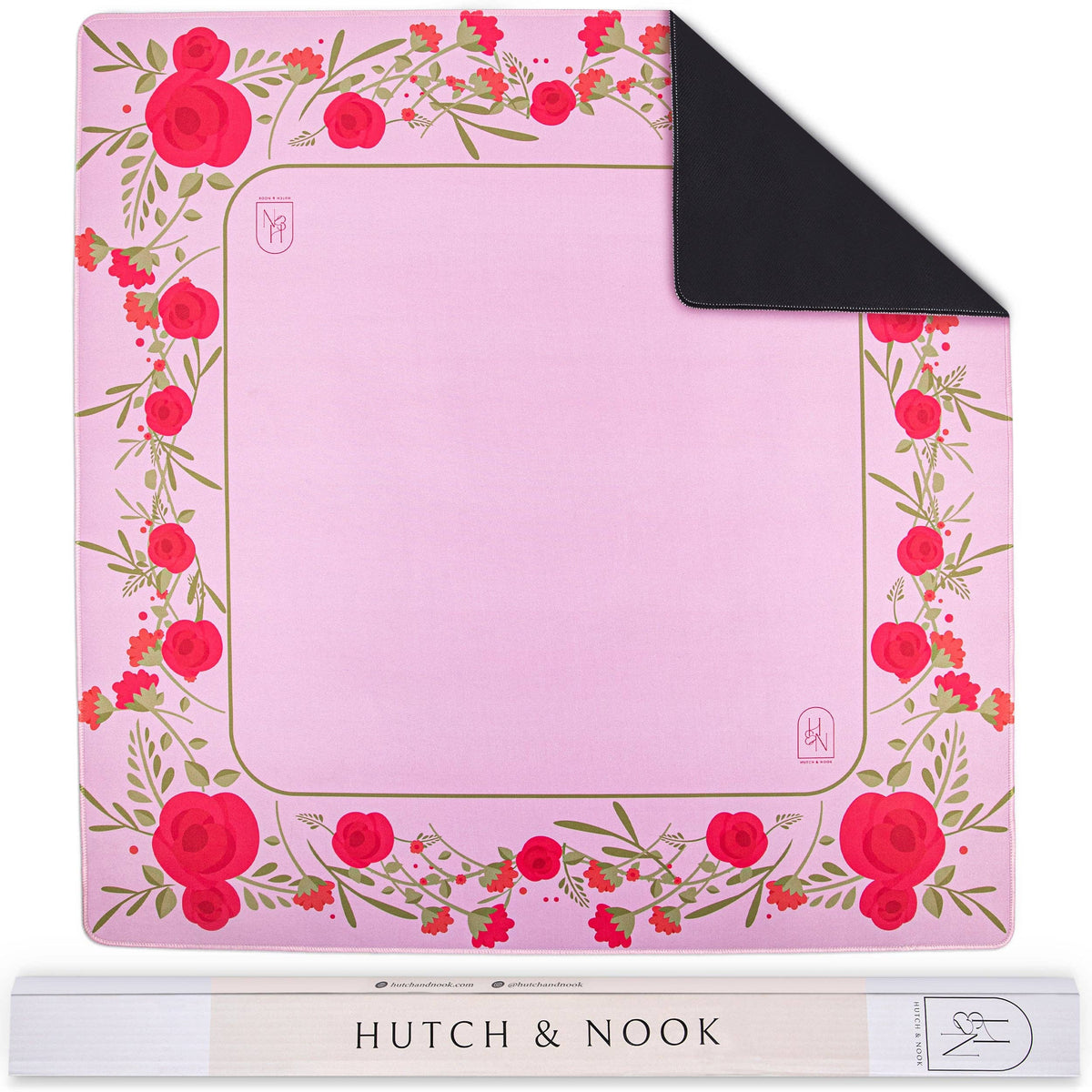 Pink floral mahjong mat with red roses and rolled storage sleeve labeled HUTCH & NOOK