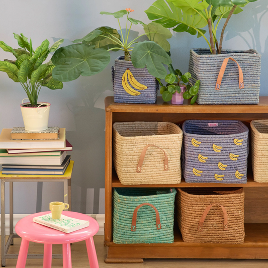 Square blue raffia storage basket with yellow banana print and side handles