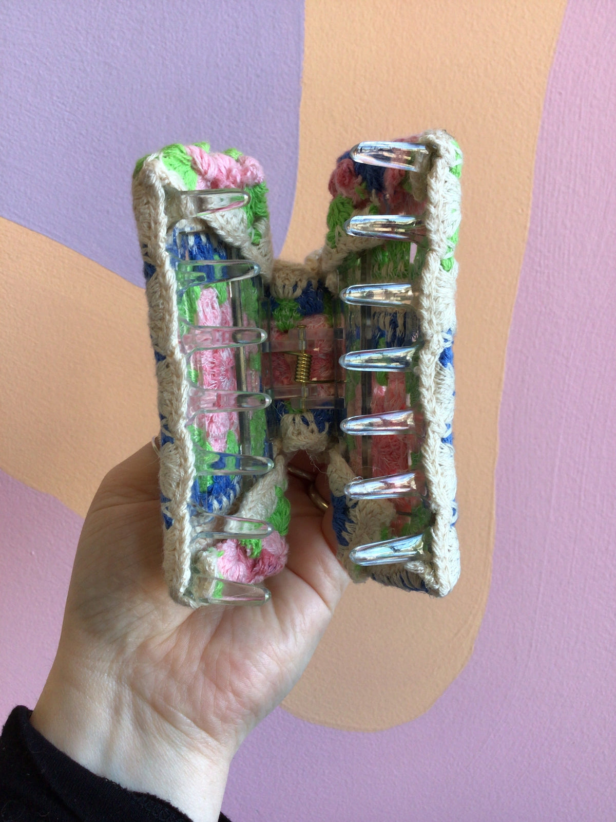 Crocheted hair claw with open view showing metal comb teeth