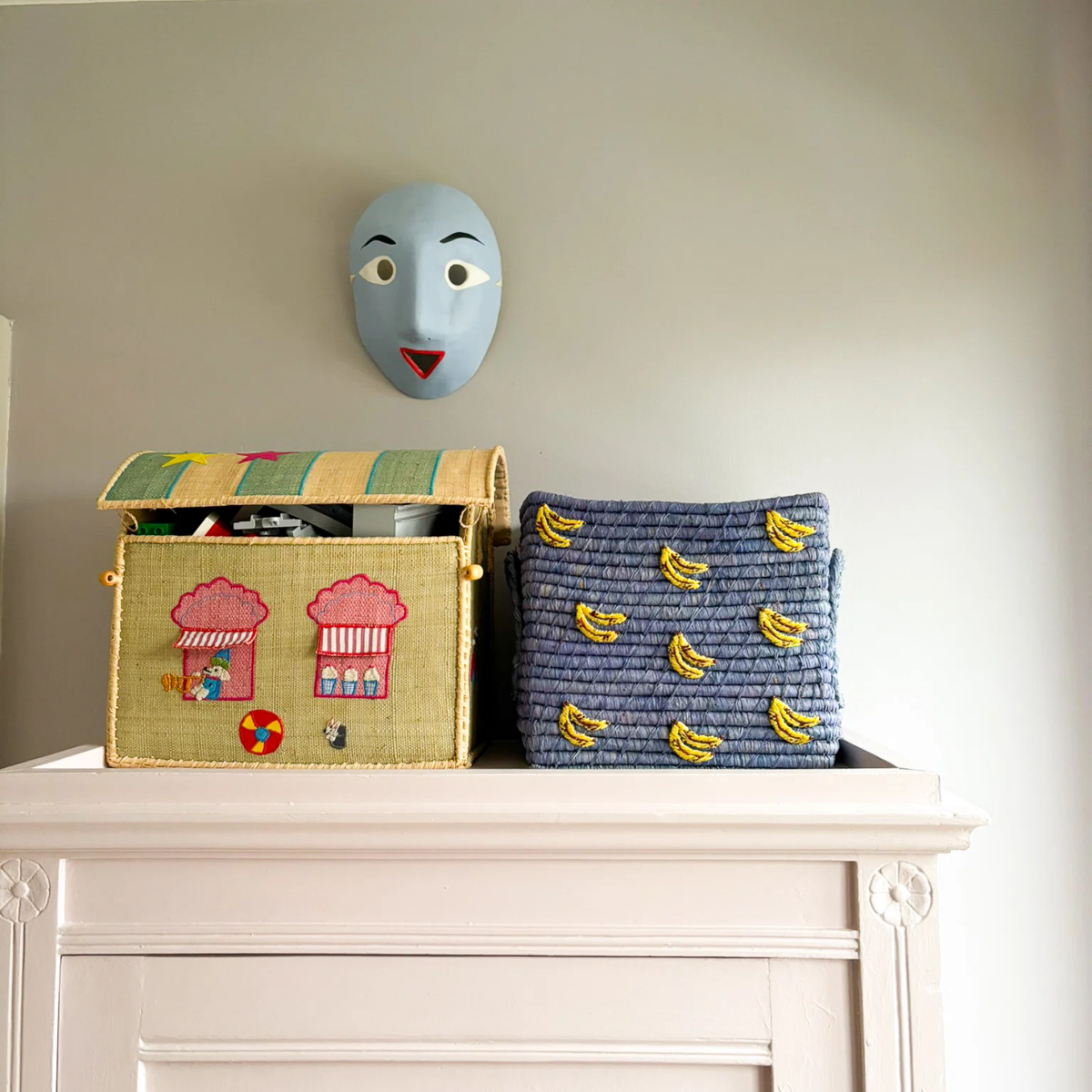 Square blue raffia basket with yellow banana motifs and open top