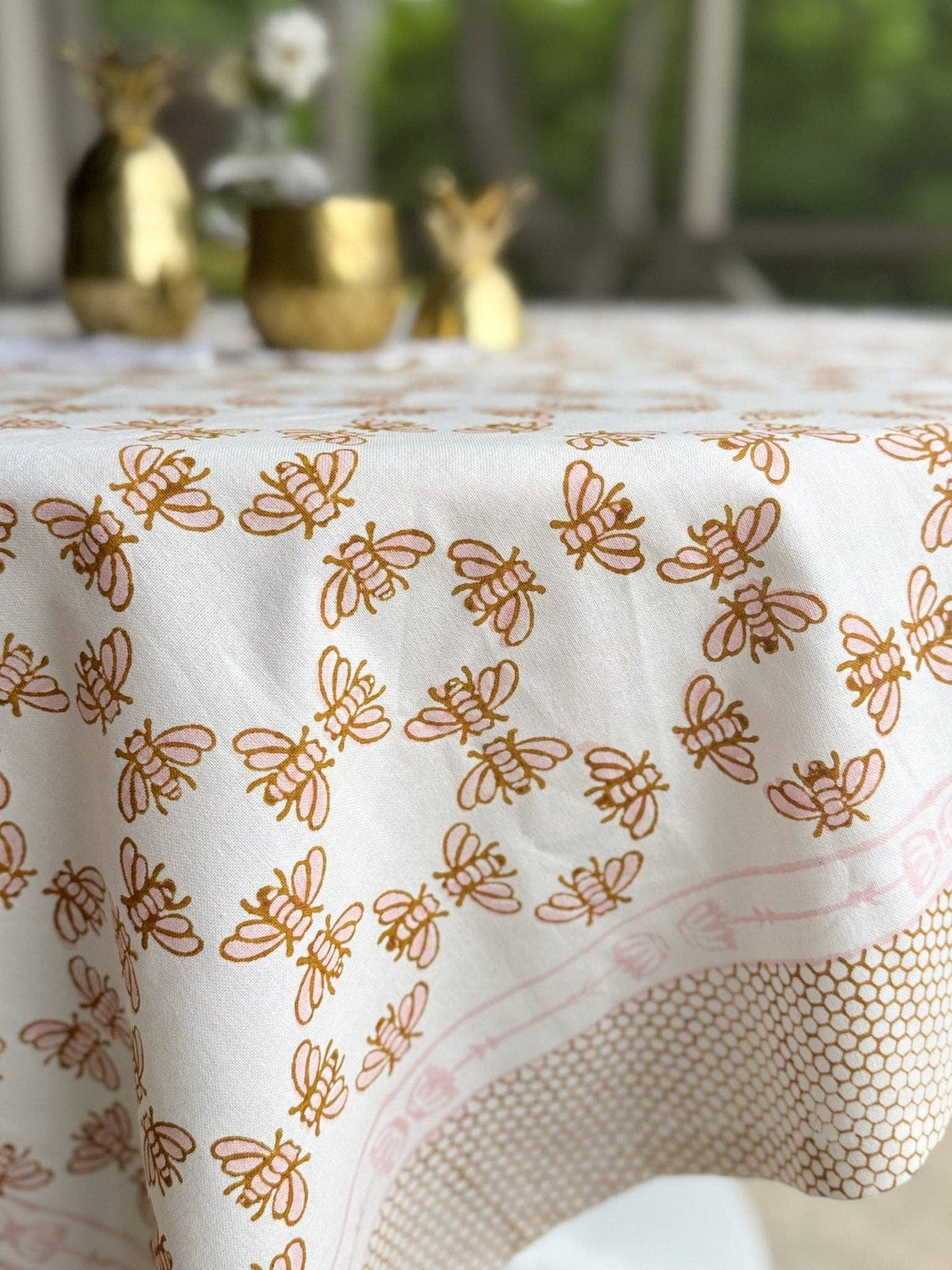White table throw with rose-and-mustard bee and vine pattern