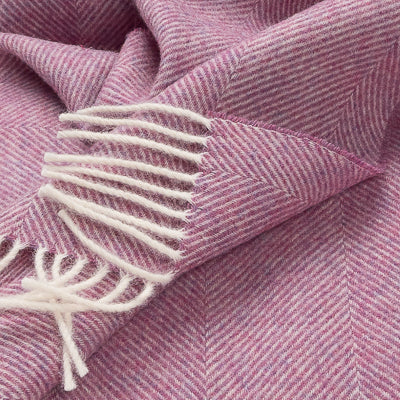 Petal pink herringbone throw with cream fringed tassels and woven texture detail