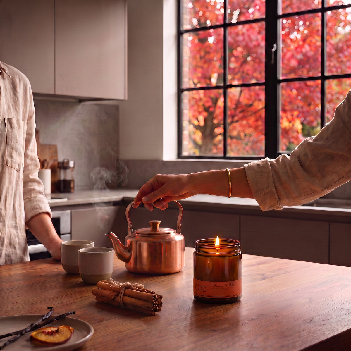 Amber soy blend candle jar with lit wick and 'bio' Fall Vibe label on countertop