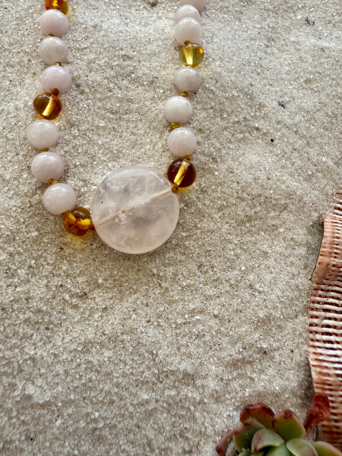 Stone bead necklace with pink beads, gold amber spacers, large oval heart pendant