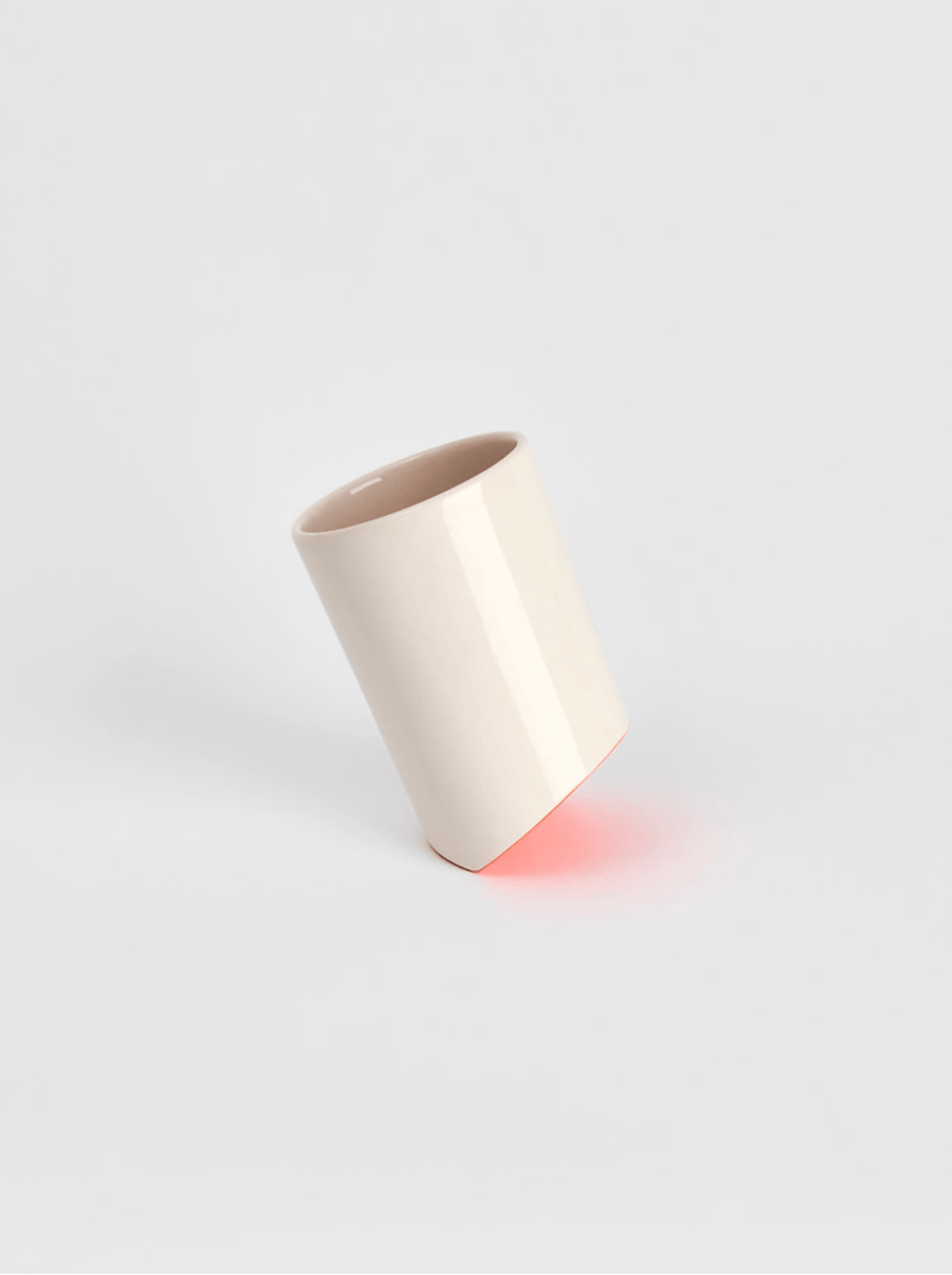 Ceramic cup in light cream with a flared rim, shown centered