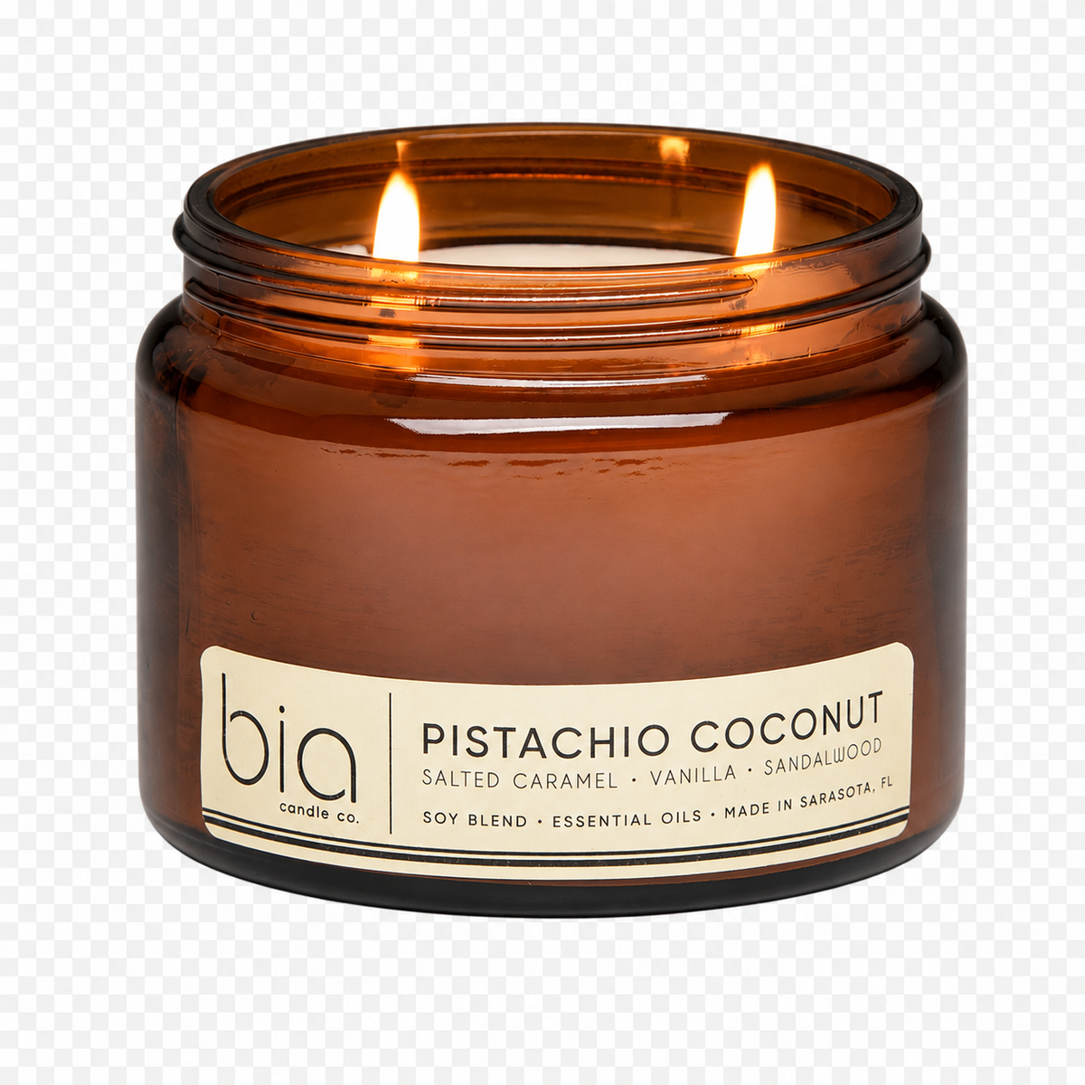 Close-up amber glass jar candle with multiple flames and cream label