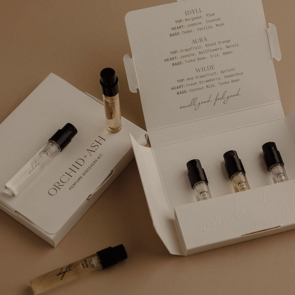 Perfume discovery kit with multiple glass vial samples in an open white box
