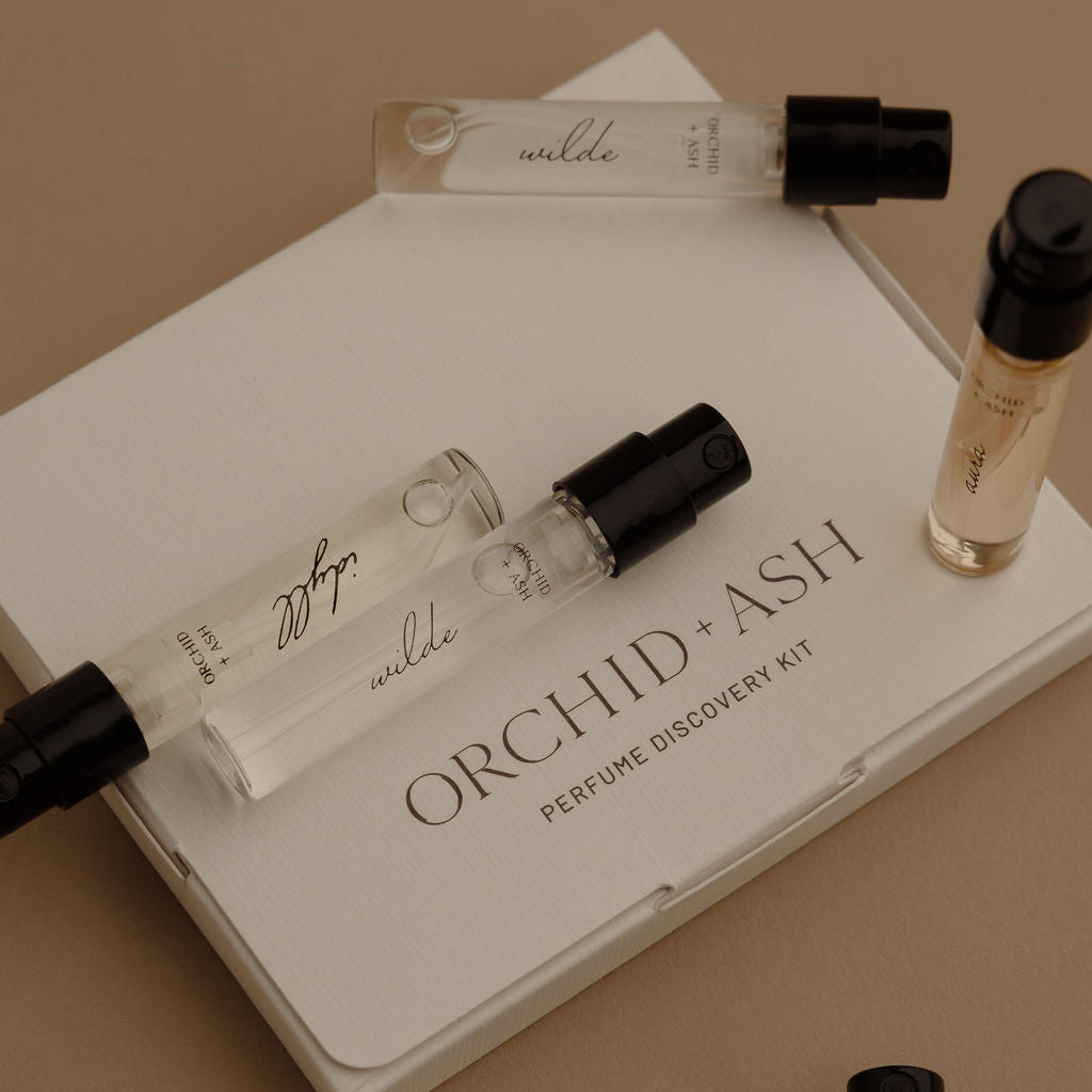 Perfume discovery kit tray with “ORCHID x ASH” and several fragrance vial samples