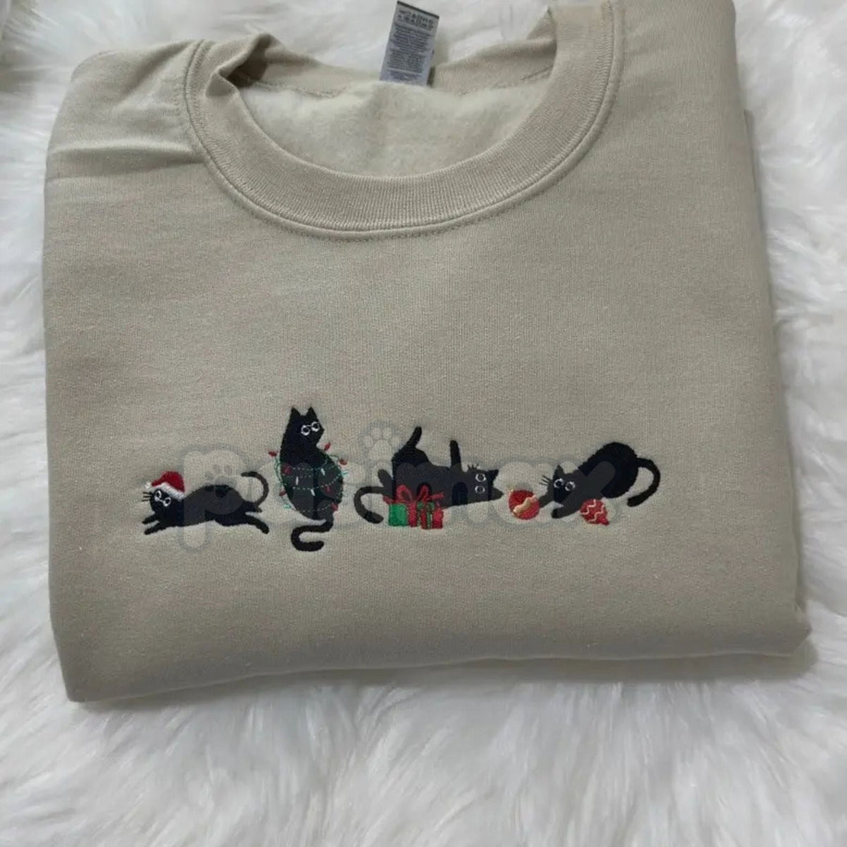 Light sand crewneck sweatshirt with black cat holiday embroidery across the chest