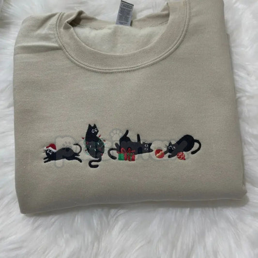 Light sand crewneck sweatshirt with black cat holiday embroidery across the chest
