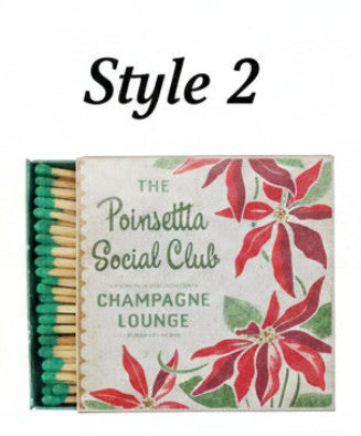 Holiday matchbox with poinsettia and 'Champagne Lounge' text; exposed matchsticks