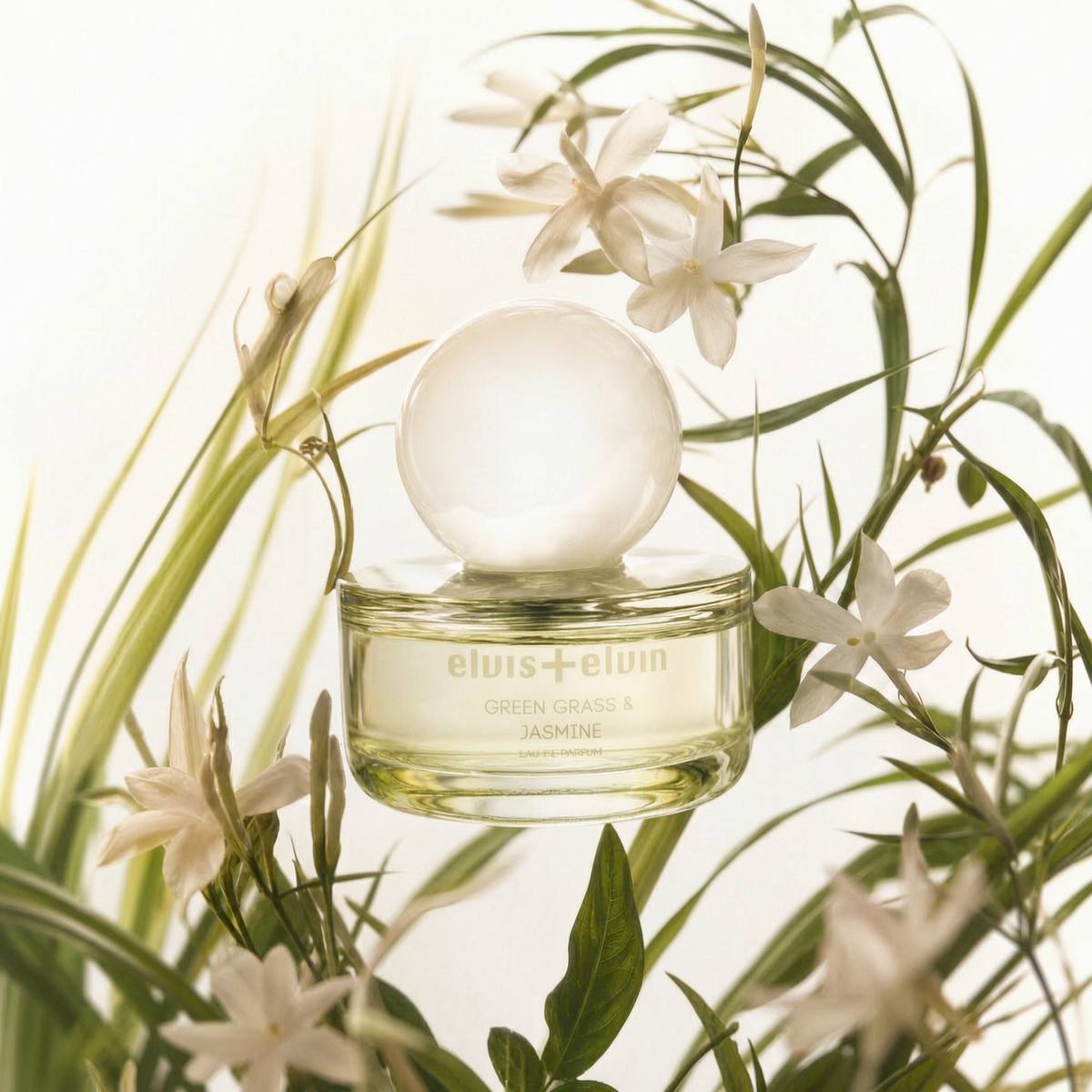 Green Grass & Jasmine Eau de Parfum bottle with white flowers and green foliage