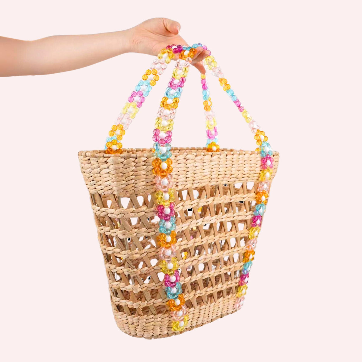 Straw beach basket tote with multicolor pom-pom beads on top handles