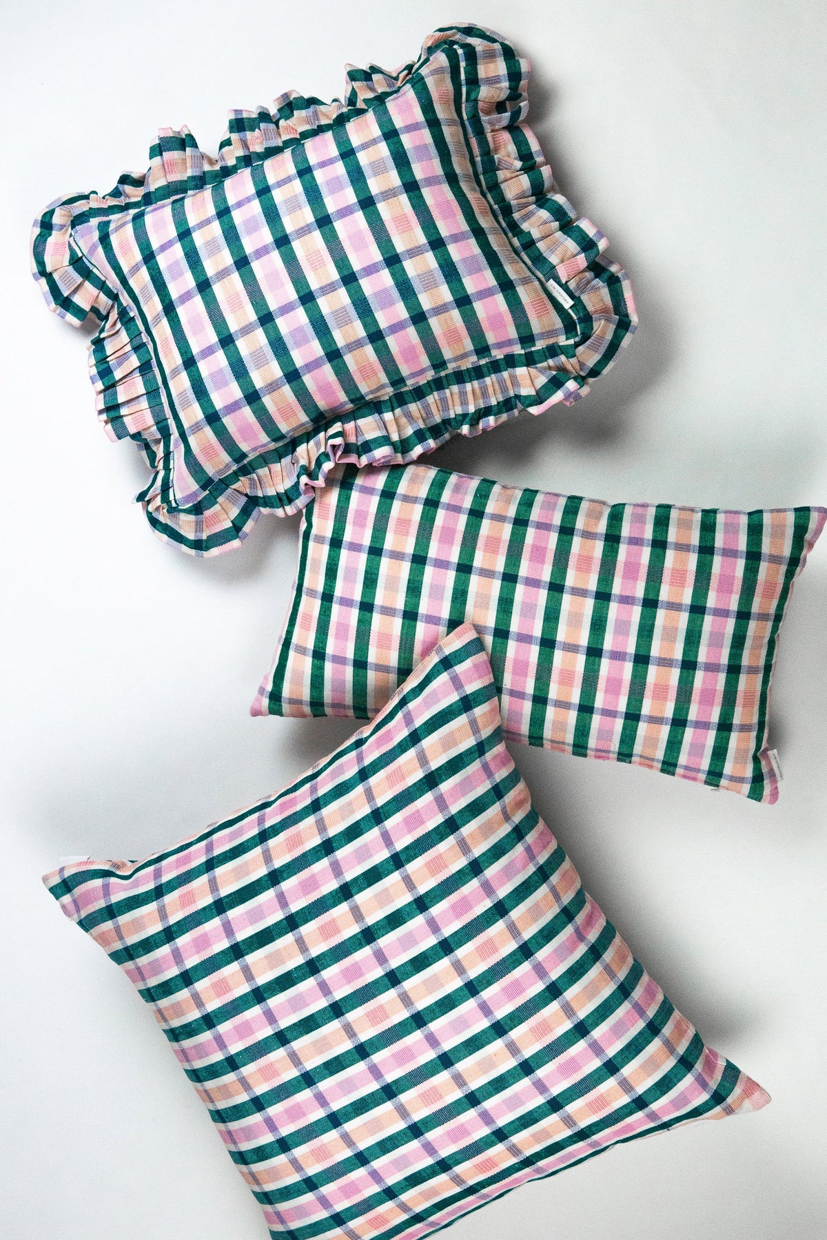 Plaid ruffle cushion pillows shown from top and side angles, colorful check