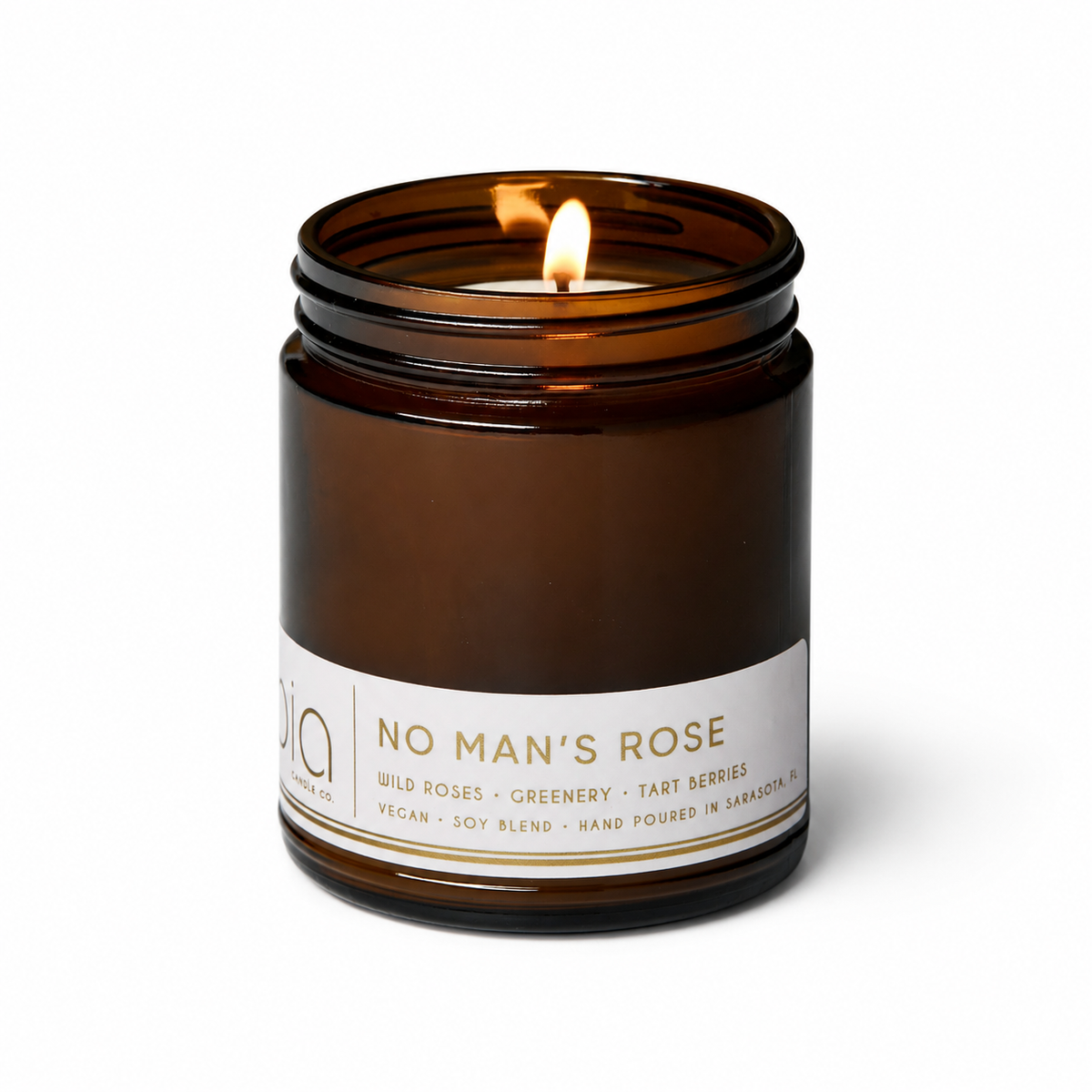 Brown amber candle jar with two flames above the wax, visible label