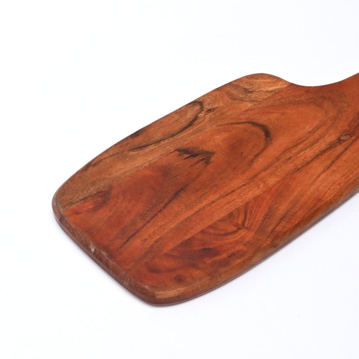 Wooden paddle cutting board with smooth worn finish and visible wood grain