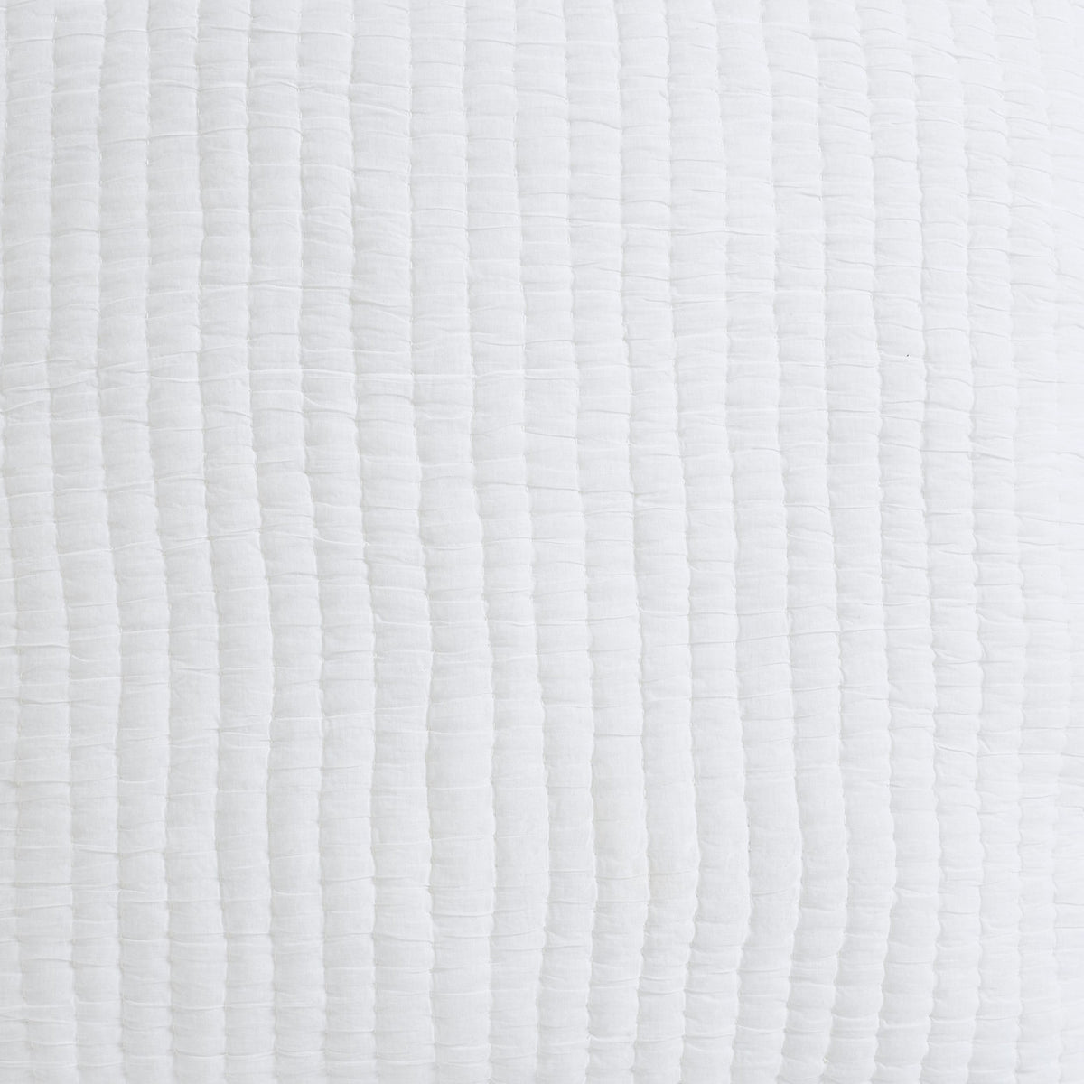 Close-up of washed cotton quilt fabric in white with quilted stitched channel texture
