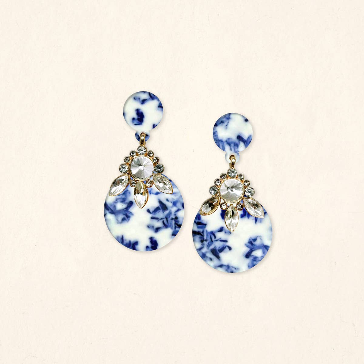 Blue-and-white drop earrings with clear crystal center and gold-tone floral details